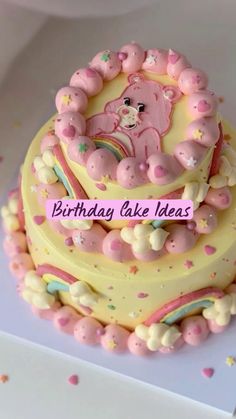 a birthday cake decorated with pink and yellow icing