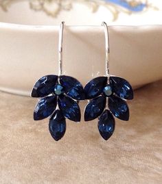 Pretty pair of sparkling leaf earrings featuring crystals in rich navy blue.   1 " long, 5/8" wide. Available in silver metal finish, as shown.  Also available in gold or rose gold plated.  Please select metal finish from the drop down menu at checkout. Thanks for stopping by! Blue Wedding Earrings, Blue Earrings Wedding, Something Blue Wedding, Earrings Bridesmaid, Something Blue, Blue Wedding, Leaf Earrings, Blue Crystals, Bridesmaid Gift