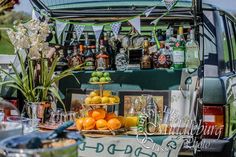 an outdoor bar with oranges, lemons and bottles