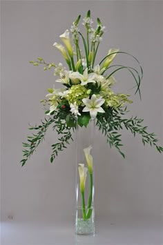 a vase filled with white flowers and greenery on top of a table next to an instagram page