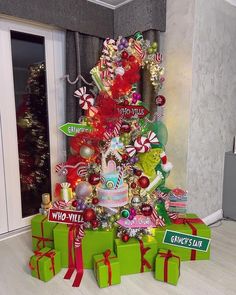 a christmas tree decorated with candy canes, candies and other holiday decor items