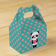 a paper bag with a panda bear and hearts on the front, sitting on a wooden surface