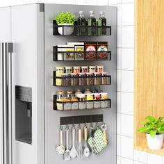 an organized kitchen shelf with spices, herbs and utensils on the wall next to a refrigerator