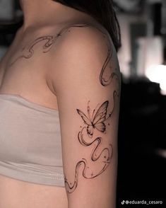 a woman with a butterfly tattoo on her arm