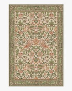 an intricately designed rug with birds and flowers in green, pink, orange and yellow