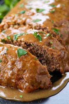 meatloaf with gravy and garnish on a plate