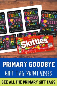 the printable skittles gift tags are on display in front of a wooden table