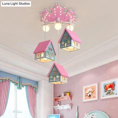 a child's bedroom with pink walls and ceiling lights hanging from the ceiling,