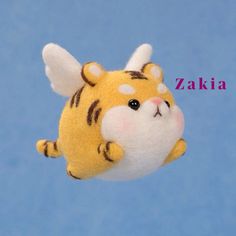 a small stuffed animal is flying through the air with its head tilted to the side