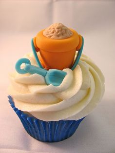 a cupcake topped with white frosting and blue icing