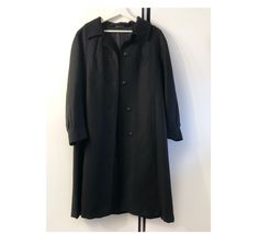 Vintage black single breasted oversized coat for women. Beautiful coat, fully lined, button closure. Material: main fabric 100% wool. Lining 100% viscose. Brand: Lacoda Made in Finland Great vintage condition According to size charts, coat would fit sizes l, xl, xxl, depending on desired fit. On size tag, would fit to: bust 100 cm, hips 110 cm Please check measurements to insure a proper fit. (You can compare this with something from your closet that fits you well.) Measured laying flat: 43 1/2" Oversized Elegant Wool Coat For Formal Occasions, Elegant Oversized Wool Coat For Formal Occasions, Elegant Oversized Single Button Outerwear, Elegant Formal Oversized Wool Coat, Oversized Long Formal Outerwear, Black Long Single-breasted Wool Coat, Oversized Long Outerwear For Formal Occasions, Long Black Single-breasted Wool Coat, Black Long Wool Coat With Button Closure