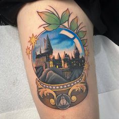 a tattoo with hogwart's castle in the glass ball and stars on it