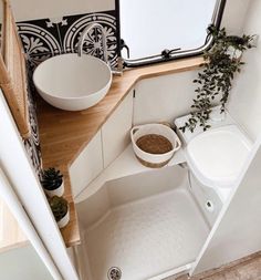 a small bathroom with a sink and toilet in it's corner area next to a window