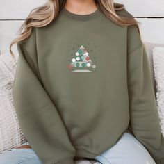 Get into the holiday spirit with our 🎄 Cozy Christmas Tree Sweatshirt! Perfect for chilly winter days, this unisex crewneck pullover features a charming Christmas tree design that brings festive cheer to any outfit. Whether you're decorating the tree, sipping hot cocoa by the fireplace, or simply enjoying a cozy night in, this sweatshirt will keep you warm and stylish throughout the season. ❄️☕️ 🎁 Perfect Gift: Looking for a thoughtful holiday gift? This sweatshirt is a great choice for friends, family, or anyone who loves to embrace the festive season. Pair it with jeans, leggings, or pajamas for a cozy, laid-back look.  🛒 Order Yours Today: Embrace the warmth and joy of the holidays with our Cozy Christmas Tree Sweatshirt. Add it to your cart now and get ready to spread some festive c Casual Christmas Crew Sweatshirt, Casual Christmas Crew Neck Sweatshirt, Crew Neck Sweatshirt For Winter Gift, Christmas Sweatshirt Gift, Christmas Gift Sweatshirt With Relaxed Fit, Green Winter Sweatshirt For Gift, Green Winter Sweatshirt Gift, Holiday Crew Neck Sweater As Gift, Green Winter Sweatshirt For Gifts