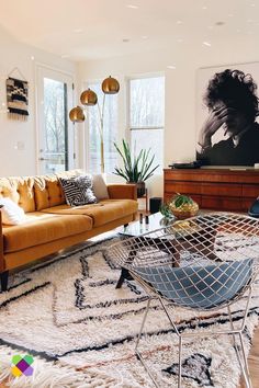 a living room filled with lots of furniture and decor on top of a hard wood floor