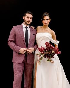 a man in a suit and woman in a wedding dress posing for a photo together