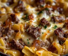 a close up of a pasta dish with meat and cheese