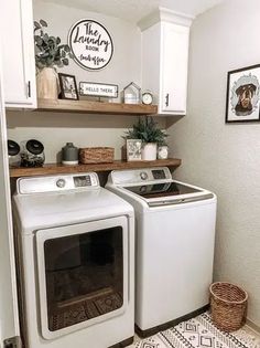 a white washer and dryer in a small room with wood shelves above them