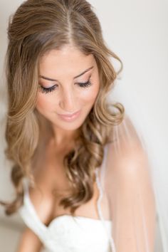 a woman with long hair wearing a wedding dress