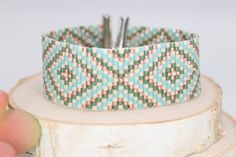 Get your boho vibes in this cream, sage green, coral, and aqua adjustable cuff style bracelet. Tiny delica seed beads sewn an intricate boho tribal pattern. Southwest boho chic at its best!Materials DelicasLead & Nickel Free Metal Slider Clasp with an Adjustable Lobster Claw & Chain Closure SIze 3/4 of an inch wide Adjustable from 6.5-8 inches long Green Beaded Friendship Bracelets For Festivals, Southwestern Green Beaded Bracelets For Festival, Southwestern Style Green Beaded Bracelets For Festival, Southwestern Style Green Bracelets For Festivals, Beaded Southwestern Bracelets For Beach, Bohemian Green Friendship Bracelets With Colorful Beads, Southwestern Green Bracelets For Festival, Southwestern Adjustable Beaded Bracelets, Handmade Green Southwestern Beaded Bracelets