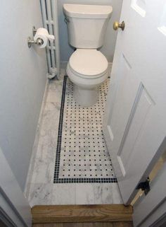 a white toilet sitting inside of a bathroom next to a door