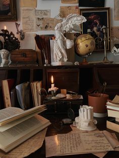 an old desk with many books and candles