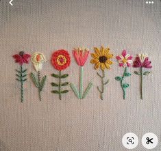 embroidered flowers are arranged in the shape of letters