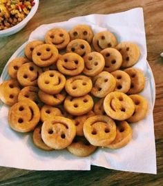 a bunch of doughnuts that are sitting on a napkin next to a bowl of cereal