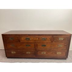 a large wooden dresser sitting on top of a carpeted floor