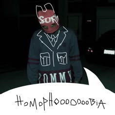 a man wearing a hoodie with the words anonymous written on it in front of him