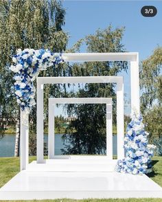 an outdoor ceremony setup with blue and white flowers