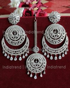 Bollywood traditional ethnic fashion Bridal party wear zircon stones and American Diamond clear crystal rhinestone dangle earrings and maang tikka lady wedding jewellery. Earrings lock is press or post type. Silver Plated drop earrings jewellery can be used on marriage,engagement,birthday and any occasion. Care Tip - 1. Keep away from moisture and perfume 2. Store in cotton or zip lock bags or air tight boxes. 3. Spot cleaning only. 4. Jewellery is the last thing you should wear and the first th Indian Jewelry Design, Maang Tika, Rose Gold Earrings Studs, Chandbali Earrings, Indian Jewellery Design Earrings, Jhumki Earrings, Maang Tikka, Indian Jewellery Design, Diamond Jewelry Designs