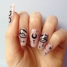 a person holding up their hand with some nail art on it's fingers and the nails