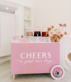 a pink sign that says cheers to guests