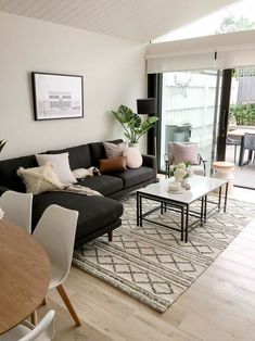 a living room filled with furniture next to a sliding glass door