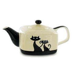 a black and white teapot with two cats on it