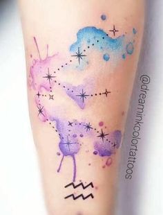 the tattoo on the leg is colorful and has stars, clouds and zodiac signs painted on it