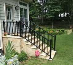 a black iron stair rail next to a house