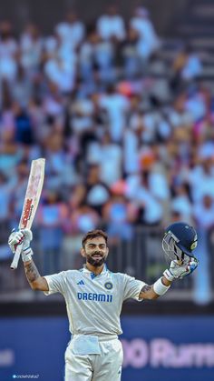 a man holding a cricket bat in his hands