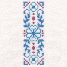 a cross stitch pattern on white paper with blue and red designs in the center,