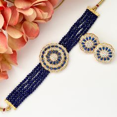 "American diamond cz kundan necklace choker set.  This kundan set features a geometric shape in a gorgeous blue, mint or pink color scheme adding a touch of modern elegance.  You'll definitely stand out wearing this beauty!  Set includes: necklace and earrings Earrings L: 1\" | W: 1\" Items are carefully packed and ready for gifting. All pictures are taken in natural light please allow for slight variations in color due to camera settings. Jewelry Care ✨Protect your jewelry in a closed box or po Blue Bollywood Necklace For Receptions, Blue Kundan Jewelry With Meenakari, Blue Temple Jewelry With Round Shape, Blue Hand Set Necklace For Diwali, Blue Kundan Necklaces For Reception, Blue Kundan Necklace For Festive Reception, Blue Kundan Necklace For Reception Festivities, Blue Kundan Temple Jewelry Necklace For Diwali, Blue Kundan Necklace For Reception And Festive Occasions