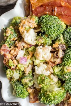 broccoli, cauliflower, and bacon salad on a white serving dish