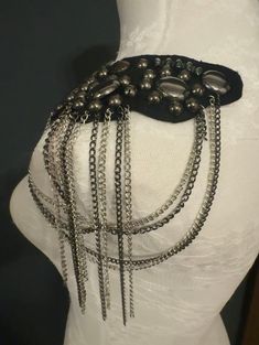 a white mannequin with metal chains on it