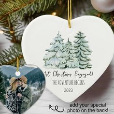 an ornament shaped like a heart with a couple kissing in front of trees