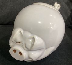 a white ceramic pig head sitting on top of a couch