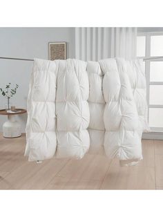 a large white mattress sitting on top of a wooden floor