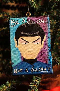 an ornament hanging from a christmas tree with a star trek character on it