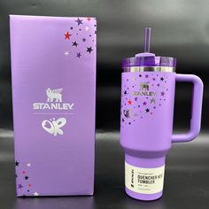 a purple travel mug next to a box