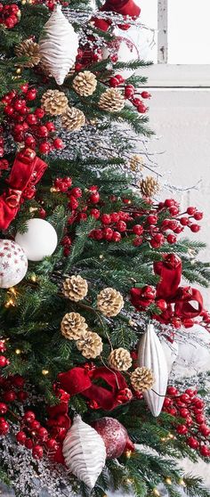 a decorated christmas tree with red and white ornaments