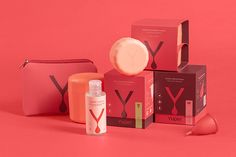 an assortment of beauty products on a pink background with the word y next to it